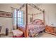 Bedroom with a four poster bed, carpet and a window with curtains at 5316 N 186Th Dr, Litchfield Park, AZ 85340