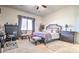 Relaxing bedroom with a comfortable bed, neutral color scheme, and ample natural light at 5316 N 186Th Dr, Litchfield Park, AZ 85340