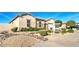 Attractive home with desert landscaping, including decorative rock and green shrubbery at 5316 N 186Th Dr, Litchfield Park, AZ 85340