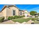 Beautiful home exterior boasting rock accents, mature shrubs, and a well-manicured lawn at 5316 N 186Th Dr, Litchfield Park, AZ 85340