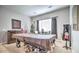 Spacious game room with covered pool table, wet bar, and ample space for entertaining at 5316 N 186Th Dr, Litchfield Park, AZ 85340
