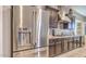 Well-equipped kitchen with stainless steel refrigerator and dark wood cabinetry at 5316 N 186Th Dr, Litchfield Park, AZ 85340