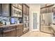 Gourmet kitchen with a pantry, double ovens, stainless steel appliances, and sleek cabinetry at 5316 N 186Th Dr, Litchfield Park, AZ 85340