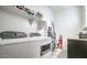 Functional laundry room featuring modern washer and dryer, shelving, and storage, maximizing convenience at 5316 N 186Th Dr, Litchfield Park, AZ 85340