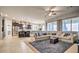 Spacious living area open to the kitchen, featuring a large sectional sofa and natural light at 5316 N 186Th Dr, Litchfield Park, AZ 85340