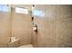 Tiled walk-in shower features a built-in niche and bench with a window at 5316 N 186Th Dr, Litchfield Park, AZ 85340