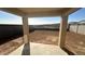 Backyard with a covered patio area, new dirt, and a partial view of the surrounding community at 5650 S 253Rd Ave, Buckeye, AZ 85326