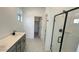 Bathroom featuring double sinks, gray cabinetry, and a glass-enclosed shower stall at 5650 S 253Rd Ave, Buckeye, AZ 85326