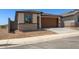 Charming single-story home featuring a two-car garage and a brick facade with desert landscaping at 5650 S 253Rd Ave, Buckeye, AZ 85326