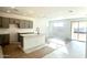 Open floor plan featuring a modern kitchen with an island and sliding glass doors to the backyard at 5650 S 253Rd Ave, Buckeye, AZ 85326