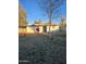 This backyard has minimal landscaping, mature trees, and a red bush by the back of the house at 6216 S 5Th Ave, Phoenix, AZ 85041