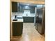 The kitchen has stainless steel appliances, ample storage, and neutral countertops at 6216 S 5Th Ave, Phoenix, AZ 85041