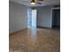 A spacious living room showcases tile flooring, a ceiling fan, and a view of the entryway at 6216 S 5Th Ave, Phoenix, AZ 85041