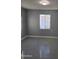 This is an empty room featuring neutral walls and flooring and a single window at 6216 S 5Th Ave, Phoenix, AZ 85041