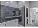 Bathroom featuring an open glass door shower with a dark tiled wall and a toilet in the background at 645 W Longhorn Dr, Chandler, AZ 85286