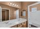 Bathroom with dual sinks, vanity with wooden drawers, and a large mirror reflecting the bathroom at 645 W Longhorn Dr, Chandler, AZ 85286