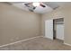 Neutral bedroom with beige walls, plush gray carpet, ceiling fan and a closet at 645 W Longhorn Dr, Chandler, AZ 85286