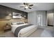 Bedroom featuring a king bed with wood accents, modern lighting, and textured dark wall at 645 W Longhorn Dr, Chandler, AZ 85286