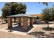 A covered picnic table at the community park is near the playground at 645 W Longhorn Dr, Chandler, AZ 85286