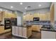 Spacious kitchen with wood cabinets, granite countertops, and stainless steel appliances at 645 W Longhorn Dr, Chandler, AZ 85286