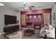 Modern living room with a fireplace, a flat-screen TV, and comfortable seating for relaxing and entertaining at 645 W Longhorn Dr, Chandler, AZ 85286