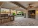 Relax in the outdoor living space with a built-in grill, mini fridge, and stone pavers at 645 W Longhorn Dr, Chandler, AZ 85286