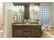 Bathroom featuring double sinks, granite counters, a bathtub, and decorative elements at 7027 W Blackhawk Dr, Glendale, AZ 85308