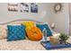 Close-up of a well decorated bed in a bedroom with mountain themed artwork at 7027 W Blackhawk Dr, Glendale, AZ 85308