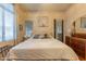 Bright bedroom featuring a large bed, neutral décor, and natural light from the windows at 7027 W Blackhawk Dr, Glendale, AZ 85308
