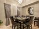 Formal dining area featuring decorative curtains, a chandelier, and seating for six at 7027 W Blackhawk Dr, Glendale, AZ 85308