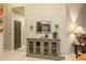 Hallway view featuring a decorative cabinet, mirror, and a glimpse into the kitchen at 7027 W Blackhawk Dr, Glendale, AZ 85308