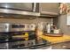 Close-up of the kitchen stove and counter area showcasing modern appliances and organized accessories at 7027 W Blackhawk Dr, Glendale, AZ 85308