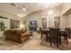Inviting living room with tile floors, stone fireplace, large windows, and a view of dining area at 7027 W Blackhawk Dr, Glendale, AZ 85308