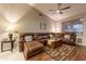 Comfortable living room with a leather sectional sofa and a patterned rug at 7027 W Blackhawk Dr, Glendale, AZ 85308