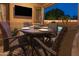 Outdoor dining area with a table, chairs, and a view of the pool, perfect for al fresco meals at 7027 W Blackhawk Dr, Glendale, AZ 85308
