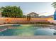 Backyard pool featuring a well-maintained yard, privacy wall, and decorative lighting at 7027 W Blackhawk Dr, Glendale, AZ 85308