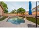 Backyard pool area featuring a lovely pool, a seating area, and well-maintained artificial turf at 7027 W Blackhawk Dr, Glendale, AZ 85308