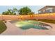 Sparkling in-ground pool surrounded by a well-manicured yard and string lights at 7027 W Blackhawk Dr, Glendale, AZ 85308