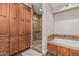Bathroom featuring a glass enclosed shower, soaking tub, and wood cabinets at 717 N Mckemy Ave, Chandler, AZ 85226