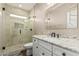 Modern bathroom featuring a glass shower enclosure, granite vanity, and decorative mirror at 717 N Mckemy Ave, Chandler, AZ 85226