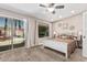 Bedroom with neutral carpet, a double window, and sliding glass doors leading to the backyard pool at 717 N Mckemy Ave, Chandler, AZ 85226
