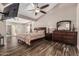 Spacious main bedroom features vaulted ceiling, wood-look tile flooring, and access to the backyard at 717 N Mckemy Ave, Chandler, AZ 85226