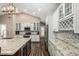Modern kitchen with granite countertops, white cabinets, stainless steel appliances, and wine rack at 717 N Mckemy Ave, Chandler, AZ 85226