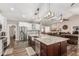 Open concept kitchen featuring a large island, stainless steel appliances, and modern lighting at 717 N Mckemy Ave, Chandler, AZ 85226