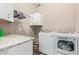 Laundry room area with white cabinets, granite countertop and modern washer and dryer at 717 N Mckemy Ave, Chandler, AZ 85226