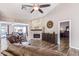 Cozy living room features a stone fireplace, wood flooring, and comfortable furnishings at 717 N Mckemy Ave, Chandler, AZ 85226