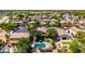 Aerial showcasing a home with a sparkling pool, mature trees, desert landscaping, and golf course nearby at 723 E Gemini Pl, Chandler, AZ 85249