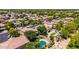 Aerial view of a home featuring a pool, lush yard, and mature trees in a quiet neighborhood at 723 E Gemini Pl, Chandler, AZ 85249