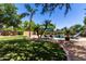 A tropical oasis with a sparkling pool, lush greenery, and rock features in a private backyard at 723 E Gemini Pl, Chandler, AZ 85249