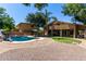 The expansive backyard boasts a sparkling pool, mature trees, and ample space for outdoor activities at 723 E Gemini Pl, Chandler, AZ 85249
